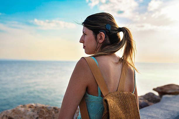 Woman wearing a hearing aid enjoying the outdoors